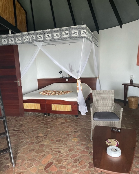      Cozy room interior with a mosquito net over the bed
  