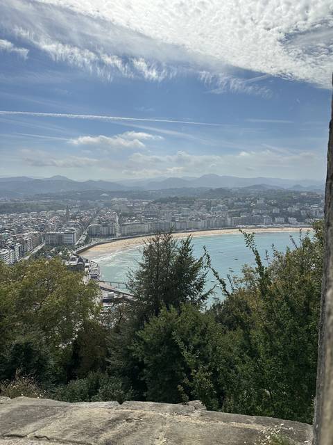 Coastal cityscape with a beach and buildings.