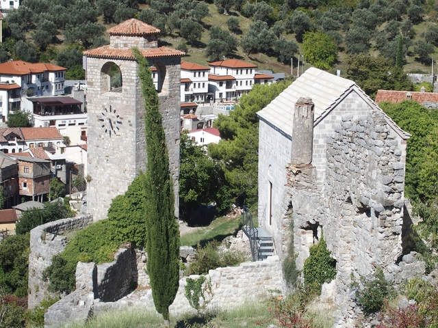 Ruins of a historic town with a bell tower.