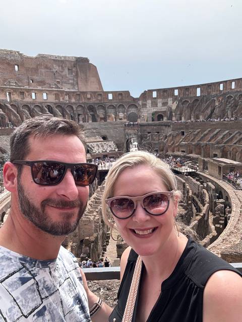 Couple posing at the Colosseum.