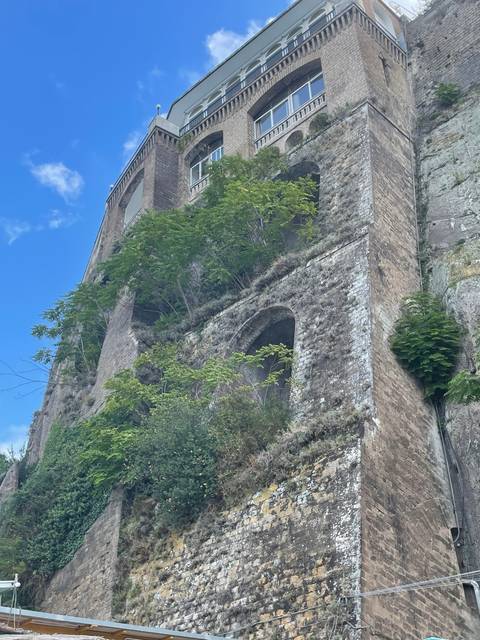 Old building with arches and vegetation growing on it