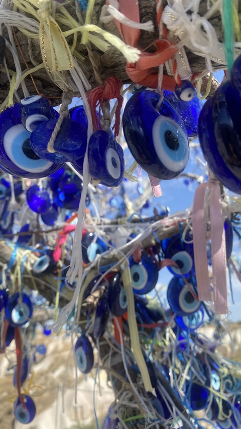 Close-up of an evil eye tree with blue ornaments.