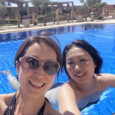 Two women enjoying a swim in a pool.