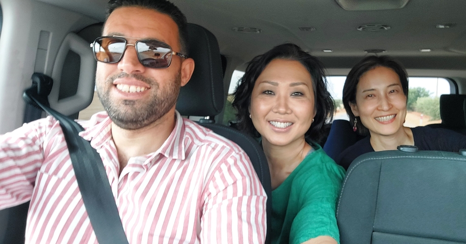 Group of people inside a car smiling.