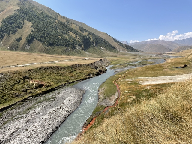       A winding river flowing through a valley.
  