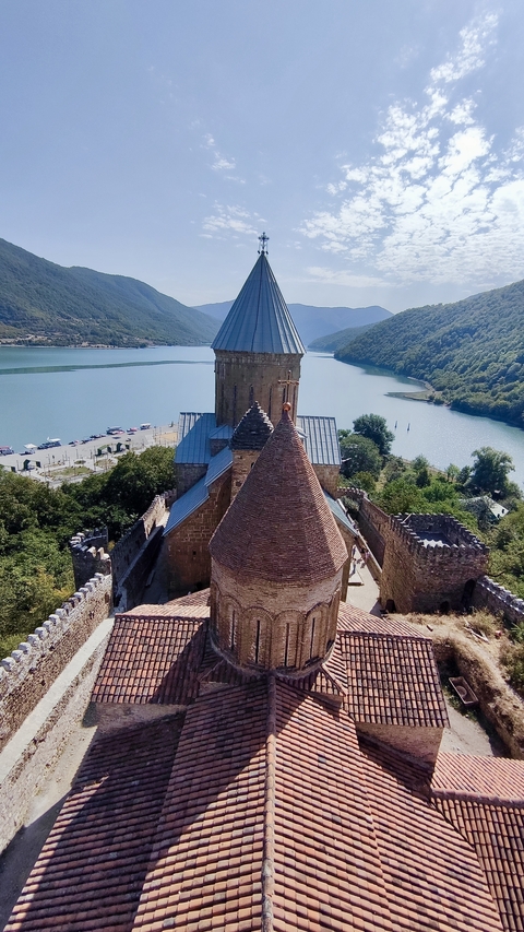       Aerial view of Ananuri fortress by a river.
  