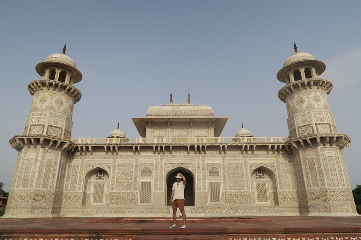 Person posing in front of Itmad-ud-Daulah's Tomb, also known as the Baby Taj.