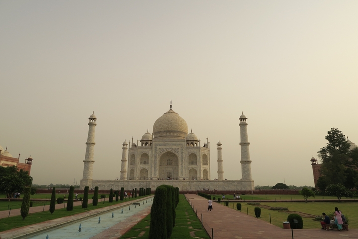 Taj Mahal with visitors in the foreground under a clear sky.