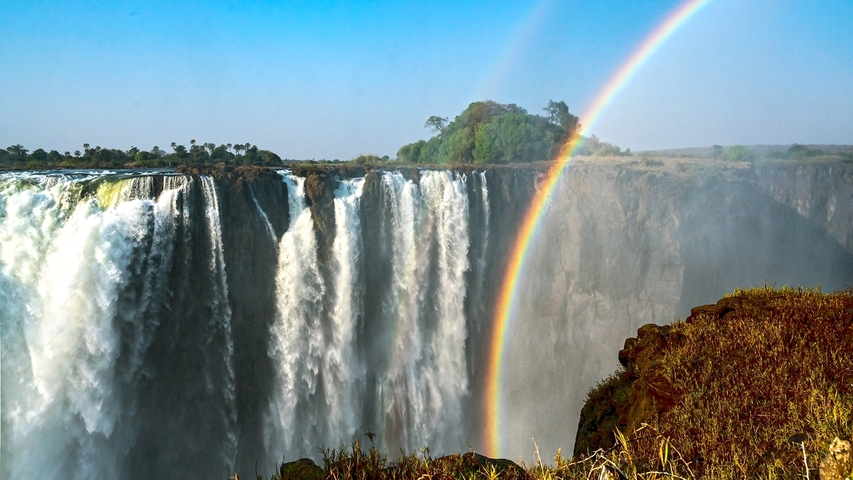       Victoria Falls with a double rainbow above the waterfall.
  