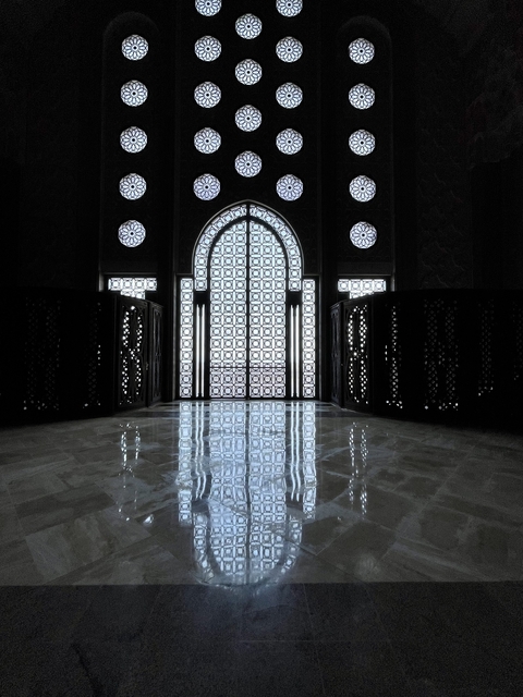       Intricate stained glass window casting patterns on the floor.
  