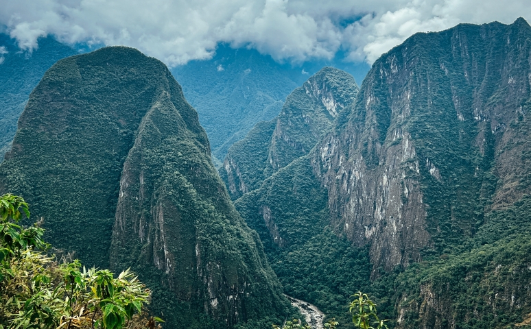 Verdant mountains under a cloudy sky.