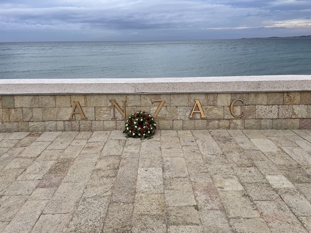 ANZAC memorial stone by the sea with a wreath.