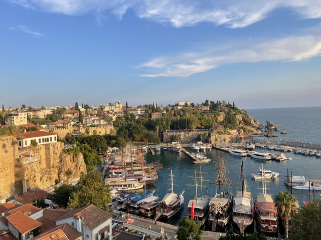 Scenic view of Antalya's old harbor with boats and buildings.