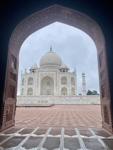 Close-up of the Taj Mahal facade through an archway.