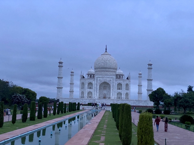 Taj Mahal under an evening sky with pools in the foreground.