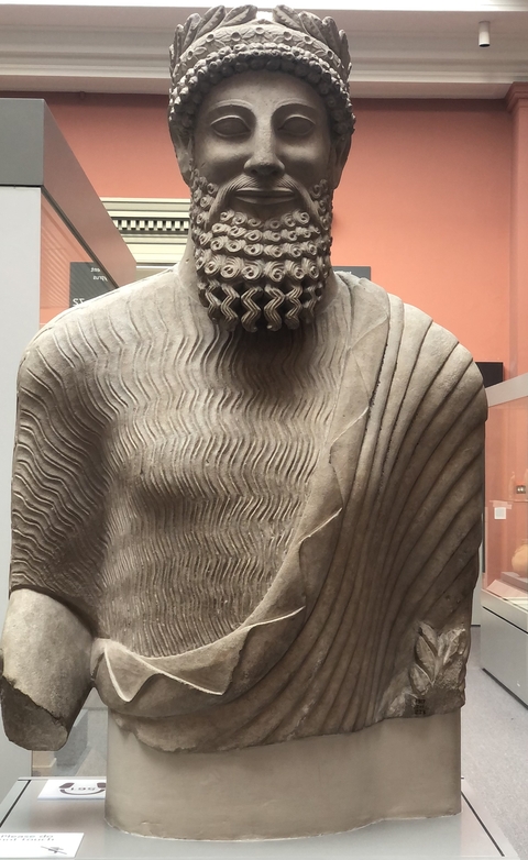       Stone statue displayed in a museum.
  
