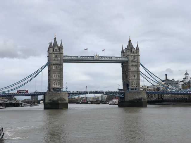       Tower Bridge over the River Thames under cloudy skies.
  