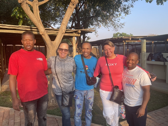       Group of people posing outdoors.
  