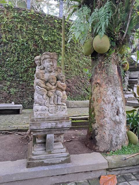 Stone statue in a natural setting.