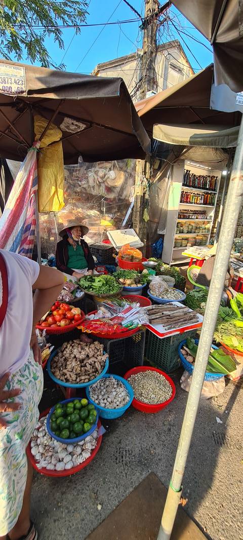       Colorful market stall selling various fresh foods.
  