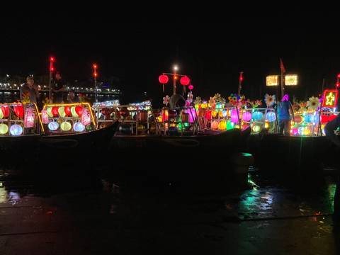       Colorful lanterns on boats at night.
  