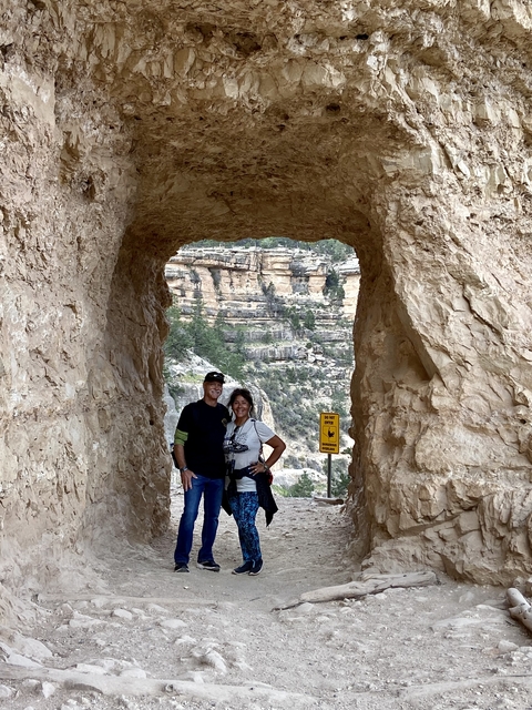Couple posing through a rock archway