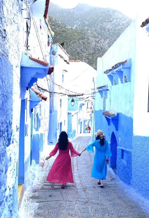 People walking through blue streets