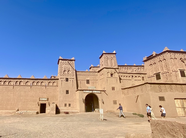      Traditional Kasbah entrance with tourists
  