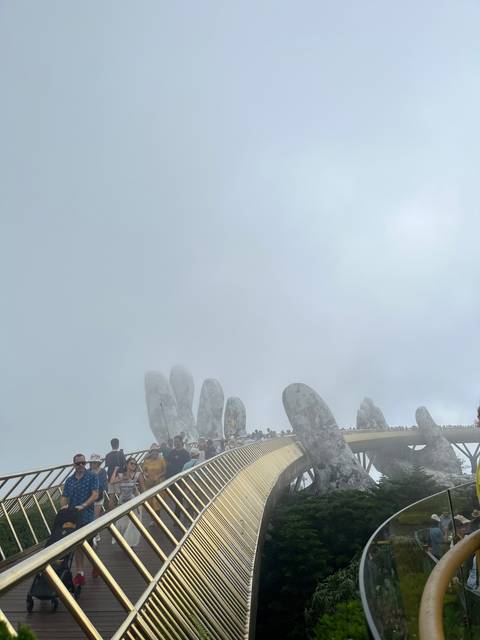 A bridge in a foggy setting with people walking.