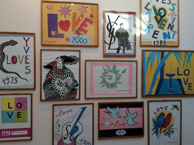       Collection of colorful posters on a wall.
  