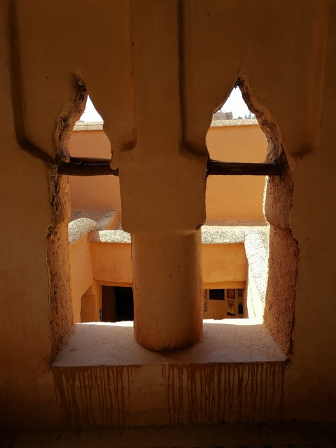       View through a stone structure with wooden elements.
  