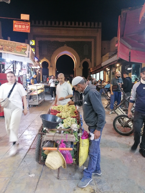       Market scene with vendors and customers.
  