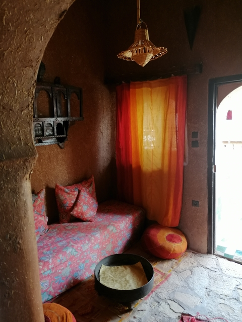       Interior room with colorful curtains and cushions.
  