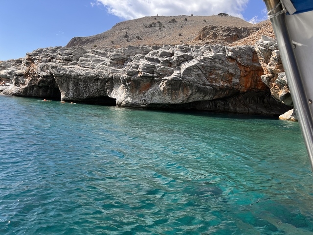       Scenic view of rocky cliffs and blue water.
  