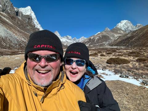 Two people in the mountains posing for a photo.