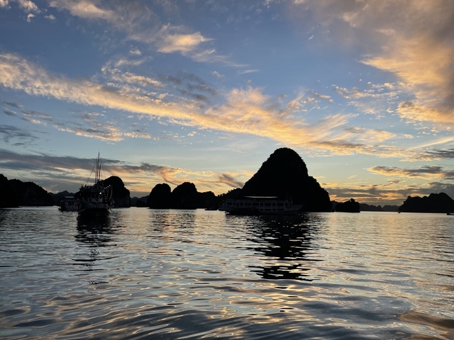 Boats on water with a dramatic sunset sky