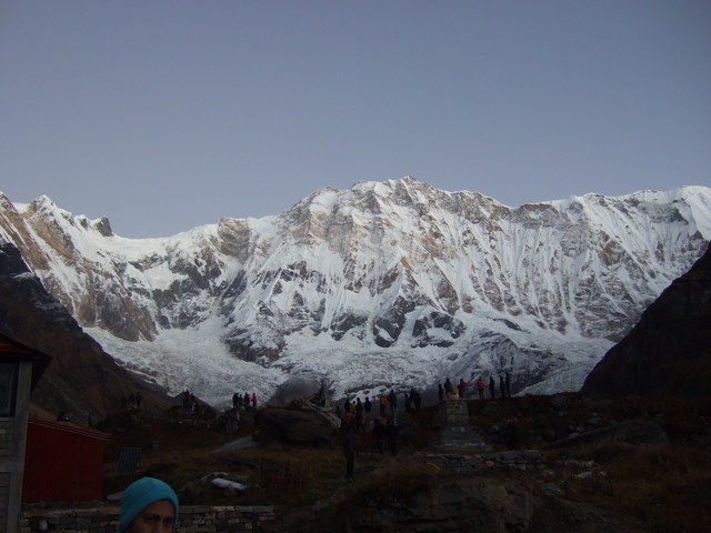       Snowy mountain landscape with group of people hiking.
  