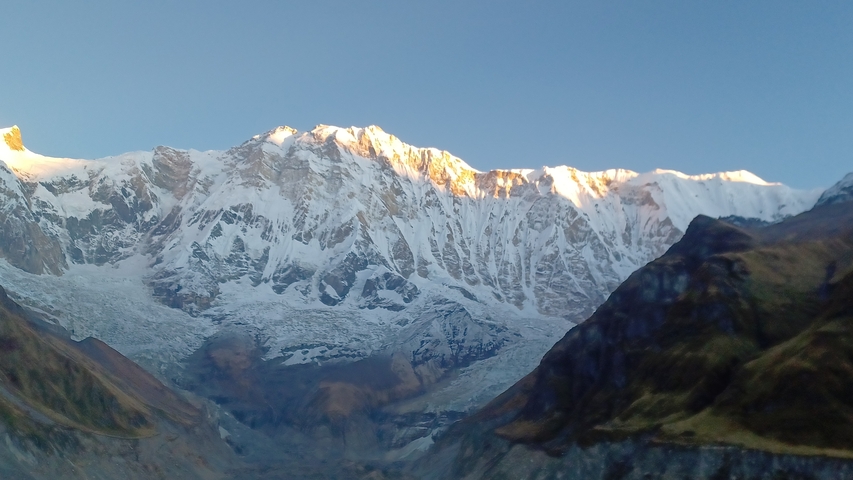       Sunrise or sunset over snow-capped mountains.
  