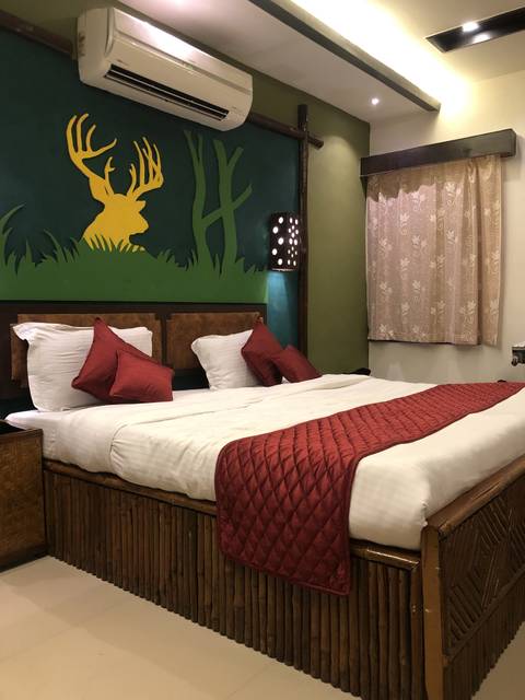       Luxurious hotel bedroom with decorative pillows and wall art.
  