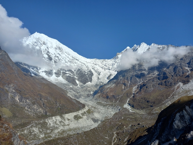 Majestic snow-capped mountain peaks under a clear sky.