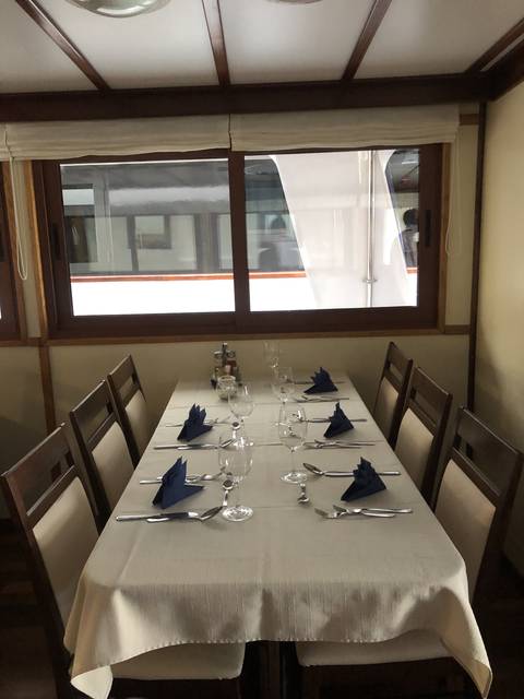 Dining table set with glasses and plates in a restaurant.