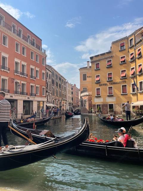 Gondola ride along Venetian canals with historic buildings.