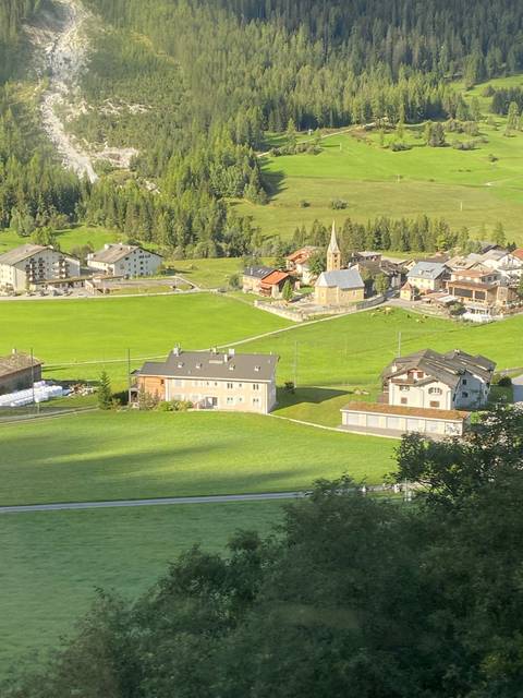       Aerial view of buildings and green fields.
  