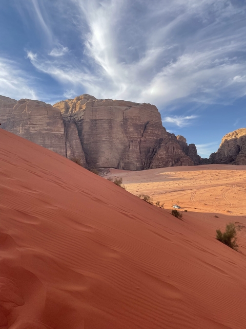 Red desert landscape with towering cliffs.