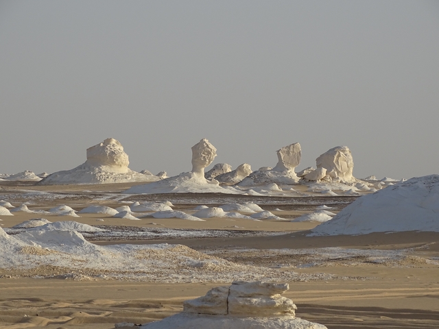       Expansive desert view with unique white rock formations.
  