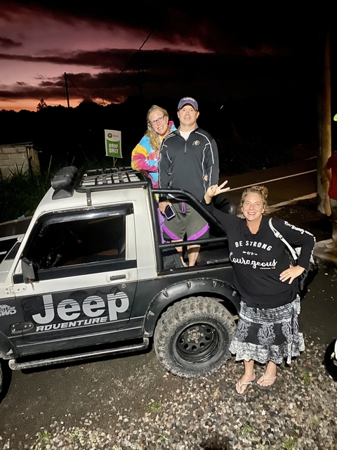 Group of people posing with a jeep.