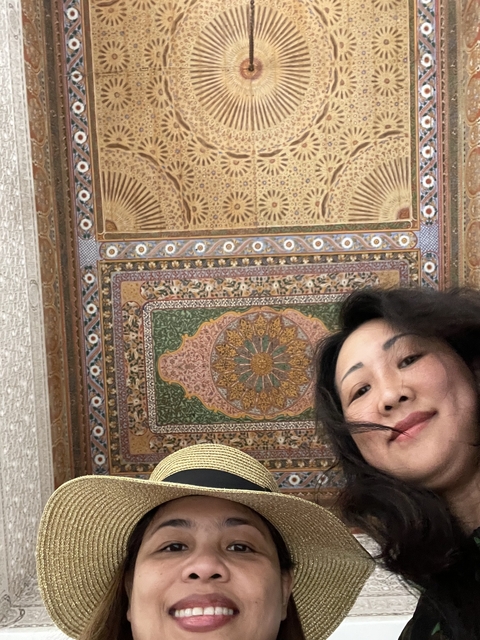       A woman underneath a decorative ceiling.
  