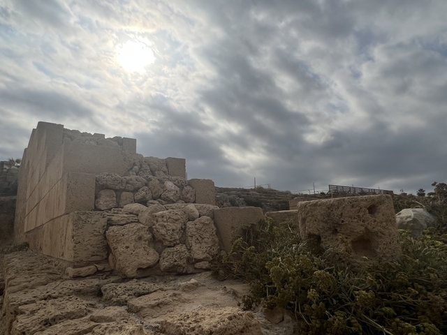       Ancient ruins under a cloudy sky.
  