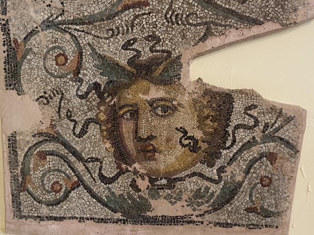       Fragment of an ancient mosaic with a face.
  