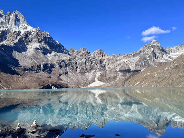       Scenic mountain lake reflecting the surrounding peaks.
  